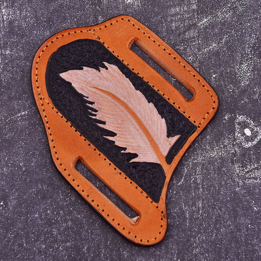 Handmade brown leather knife sheath with feather embossed design, stitched edges, and belt carry slots
