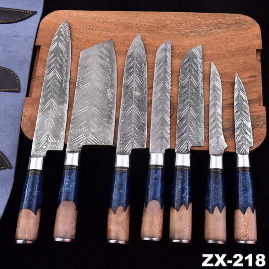 A set of seven kitchen knives with patterned steel blades and dark blue handles with natural wood grips, displayed on a wooden cutting board over a black background.