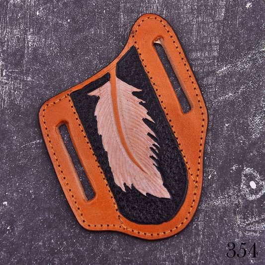 Handmade brown leather knife sheath with feather embossed design, stitched edges, and belt carry slots