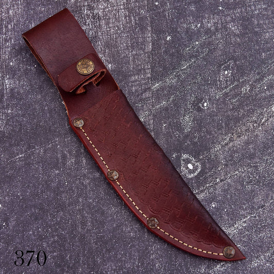 A dark reddish-brown leather knife sheath with a textured embossed pattern, cream-colored stitching, and brass snap fasteners, displayed diagonally on a textured gray background.