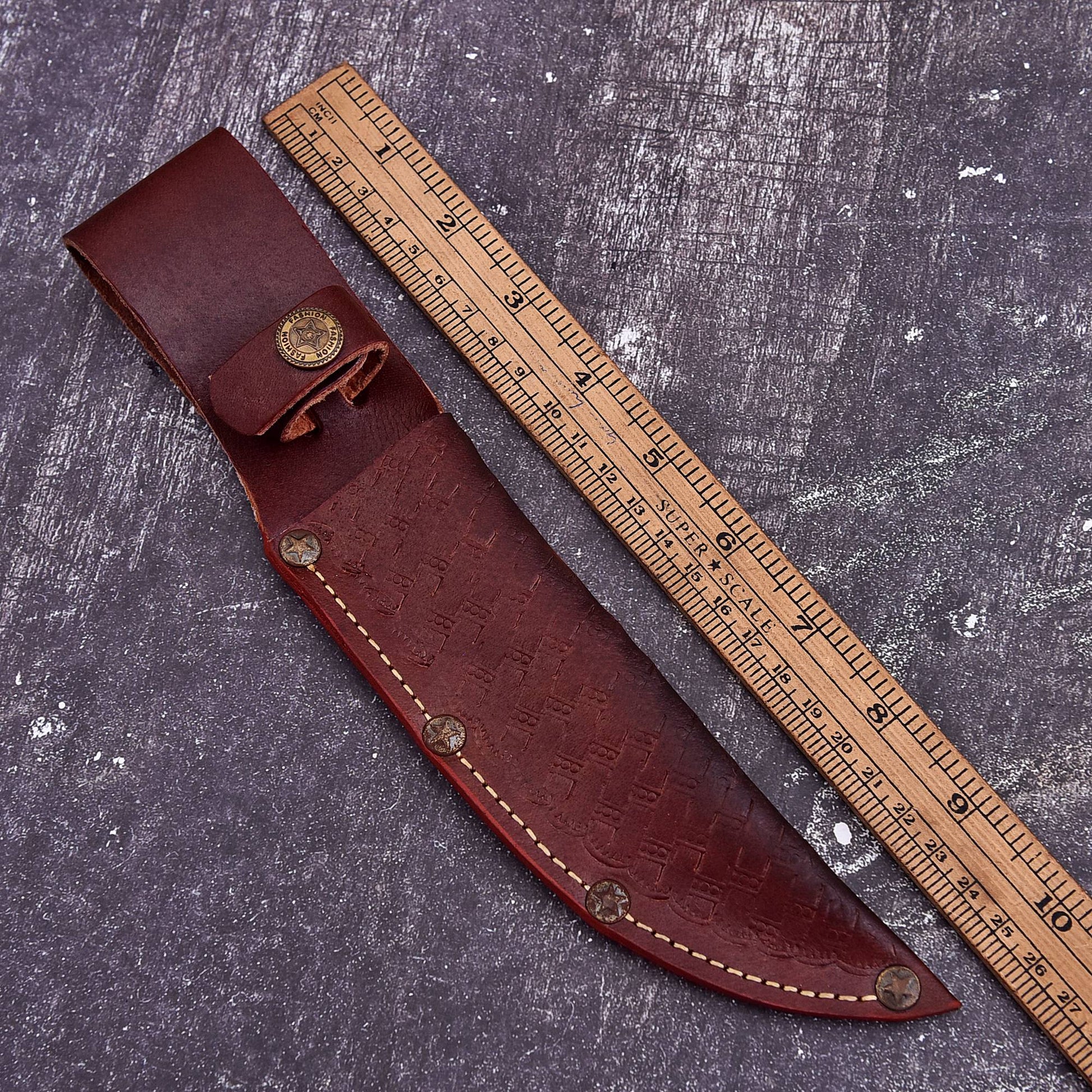 Brown leather knife carry cover with stitched edges, rivets, and curved fixed blade sheath design