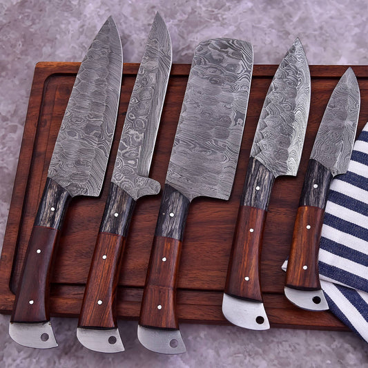 Six Damascus steel kitchen knives with dark wood handles and silver bolster ends, arranged on a dark wooden cutting board over a gray stone surface.