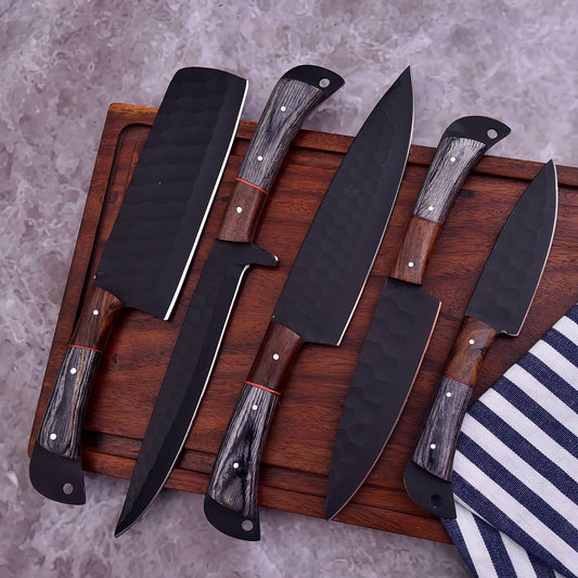 Five kitchen knives with dark steel blades and wood-grain handles arranged on a wooden cutting board over a gray stone-like surface, with a striped cloth partially visible at the lower right.