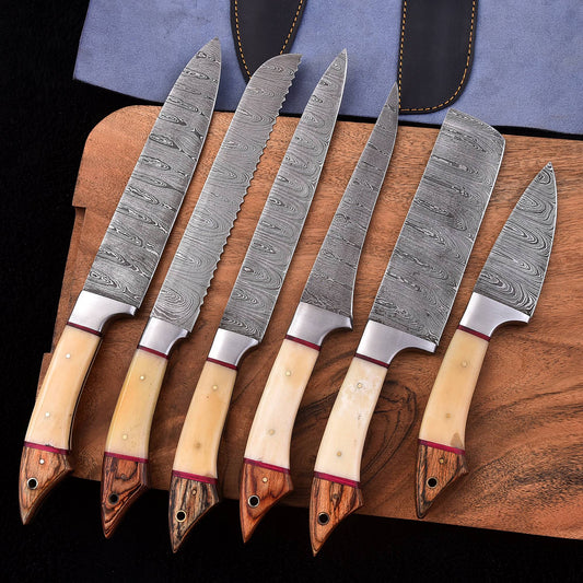Six-piece handmade Damascus kitchen knife set with light bone and wood handles, including a bread knife, cleaver and chef knives