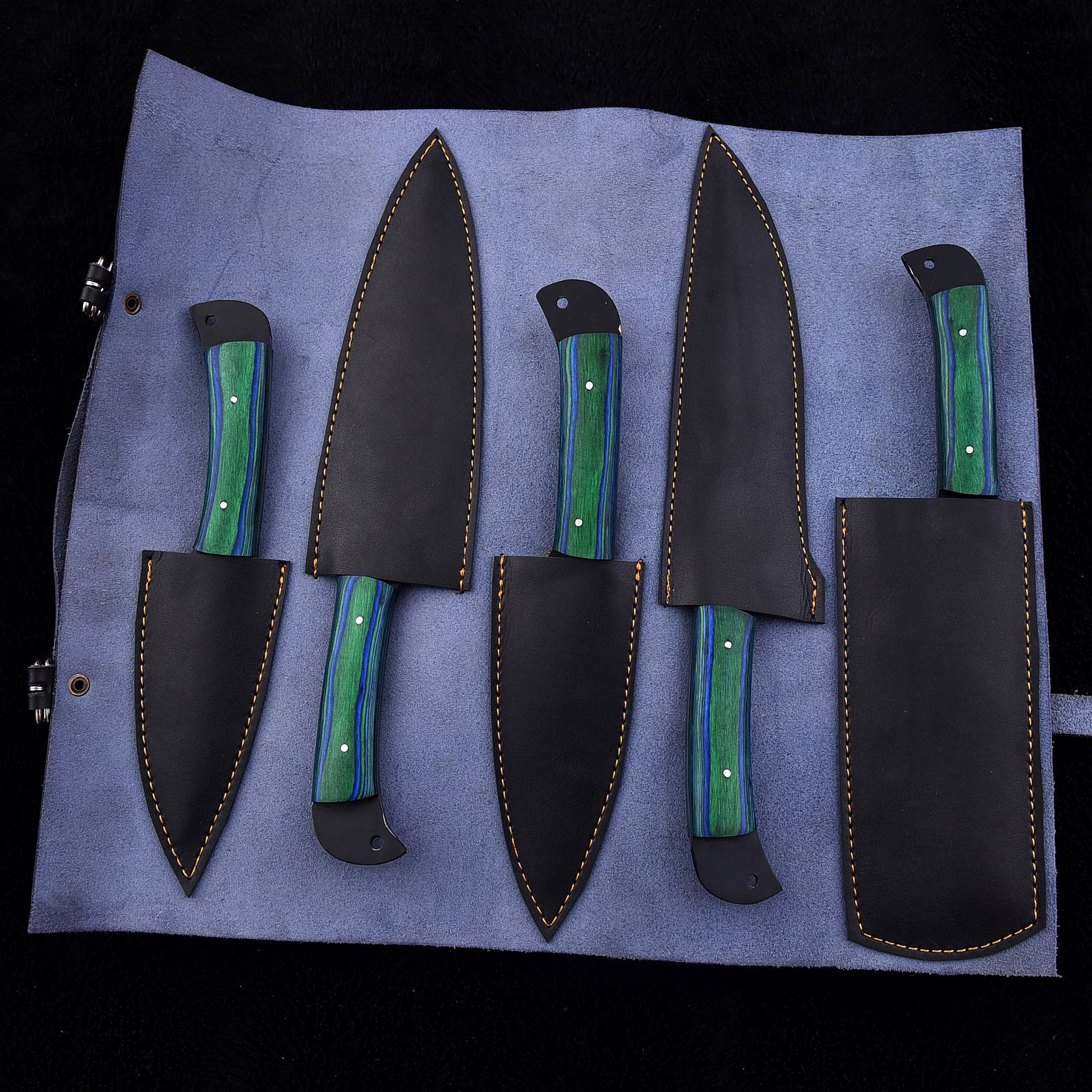 A set of four kitchen knives with green and blue marbled handles, displayed in a black leather roll with matching sheaths on a light blue fabric background.