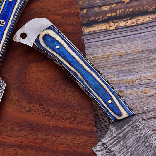 Forked axe with blue and silver handle on a wooden surface