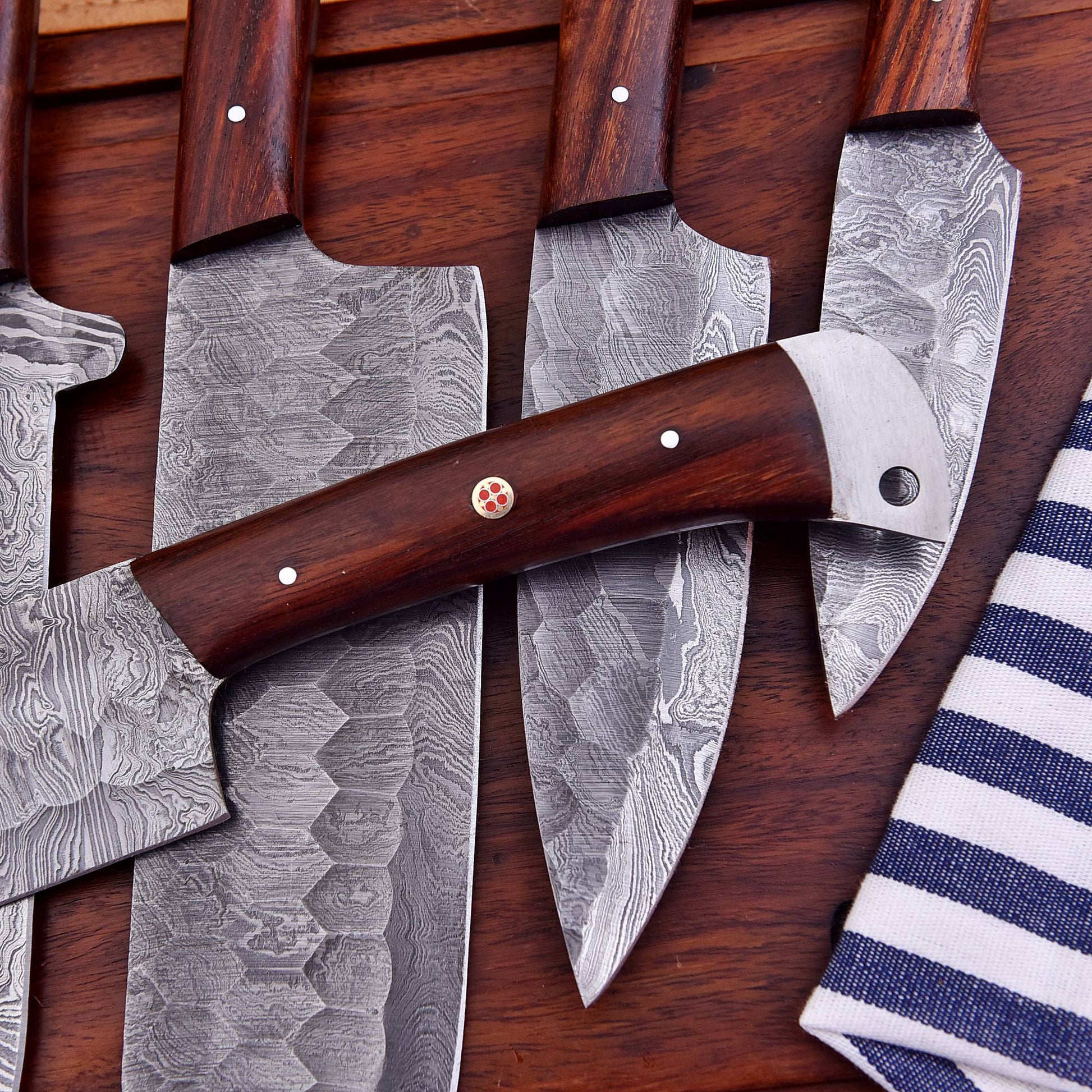 Collection of knives with wooden handles on a wooden surface