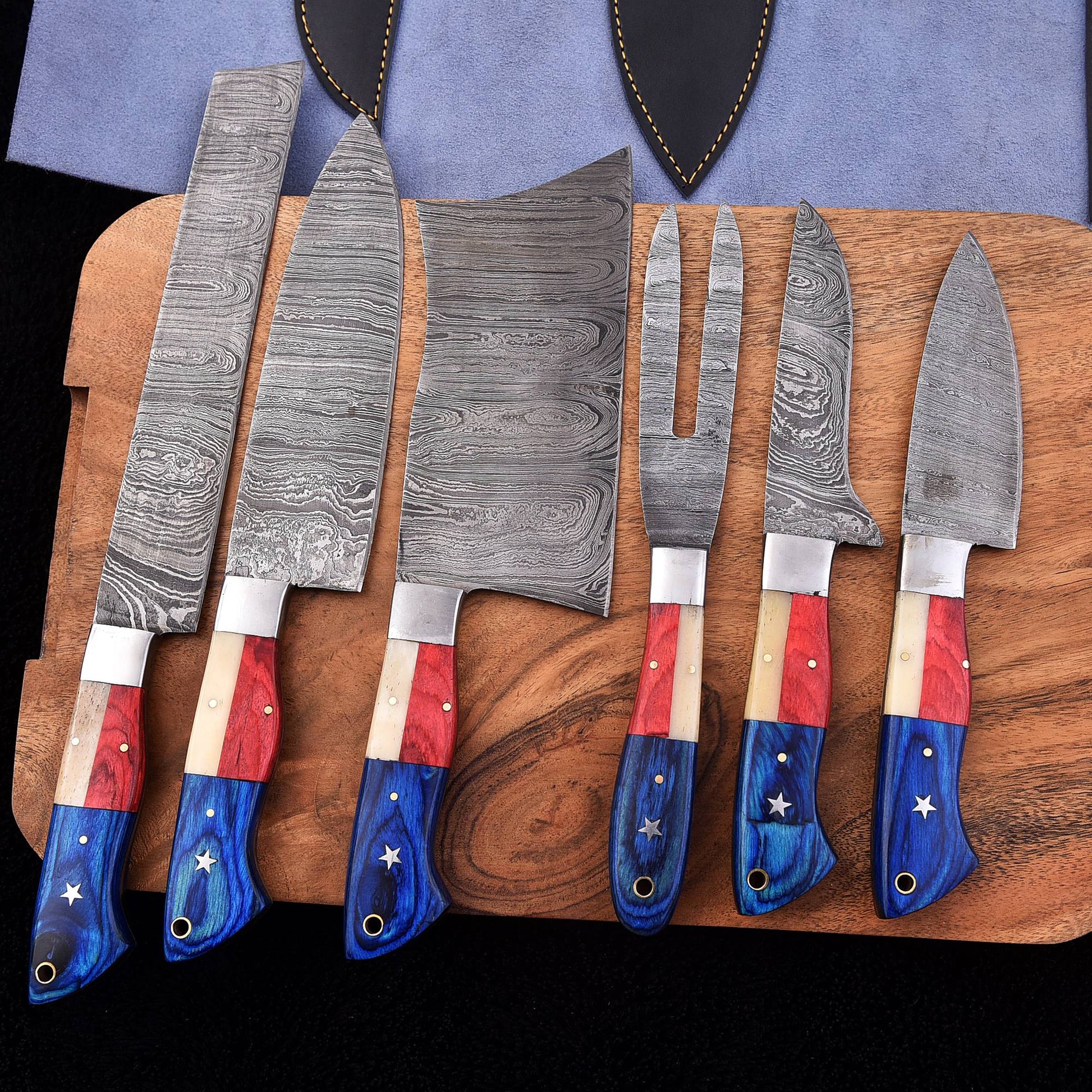 Six-piece handmade Damascus BBQ knife set with red white and blue Texas flag handles, cleaver and carving fork