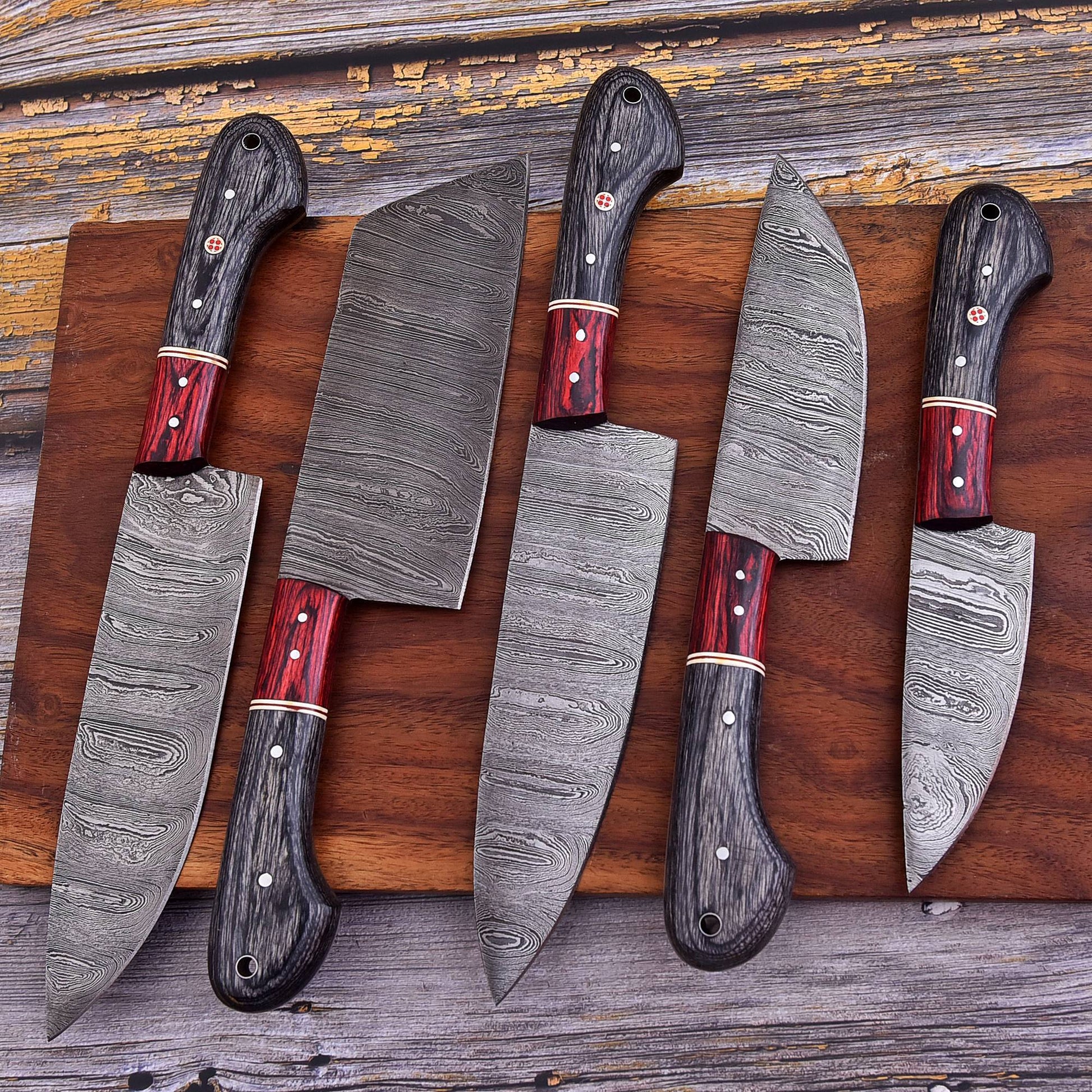 Set of knives with wooden handles on a wooden surface